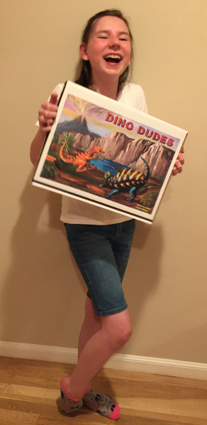 Photo of Janelle holding the Dino Dudes box